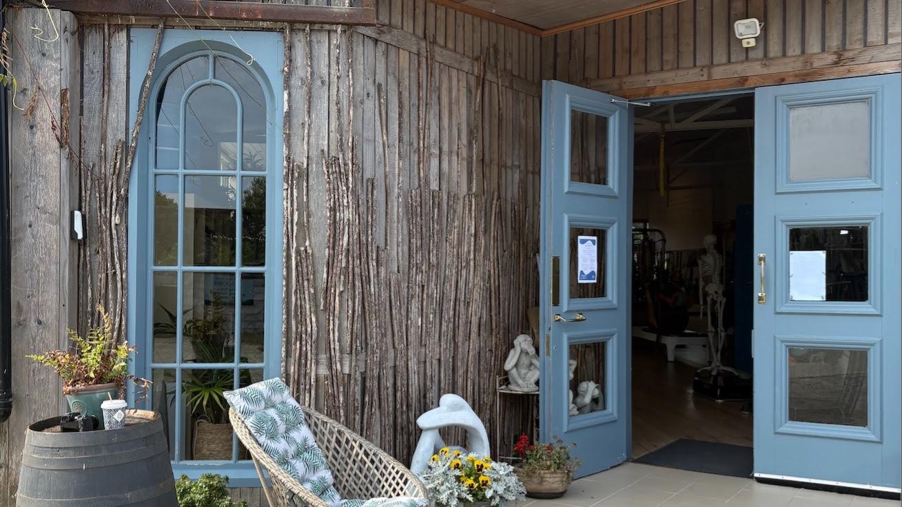 Blue arched windows and doors at the entrance to Anne Sexton Pilates studio